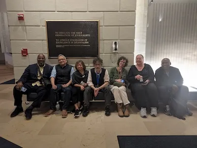 CJS faculty group photo during reporting on student protests.