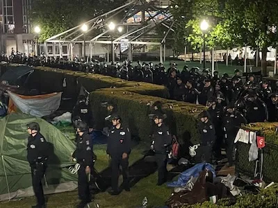 NYPD officers walk through Columbia's campus. 