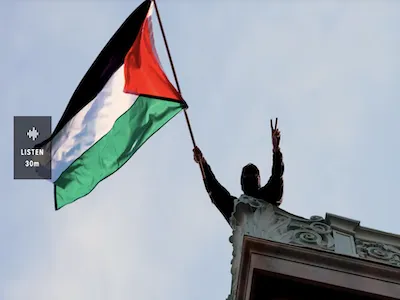A student protester waves a Palestinian flag above Hamilton Hall on the campus of Columbia University. 
