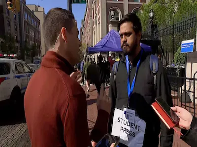 Columbia Journalism student Meghnad Bose, '24 M.S., being interviewed by a reporter. 