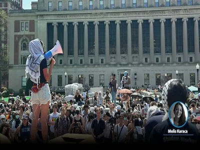 Student holds a megaphone addressing a student protest on Columbia University's campus. 