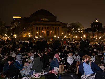 Protesters in The Gaza Solidarity Encampment gather around with blankets and food at Columbia University, in New York City on Friday, April 19, 2024. (Photo by Marco Postigo Storel)