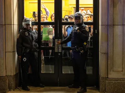 NYPD officers stand watch as they prepare to enter the campus of Columbia University. Photo: Michael M. Santiago