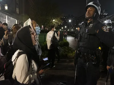 Photo of student protester and NYPD officer taken by Seyma Bayram, '19 M.S.