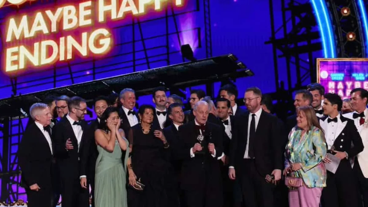 Group on stage accepts an award. 