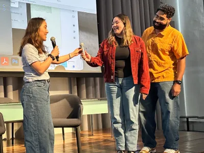 2026 Radio Race winners Chris Agbanyo and Kylie Miller (U.S.) receive their Audience Award from Professor Kat Chow. 