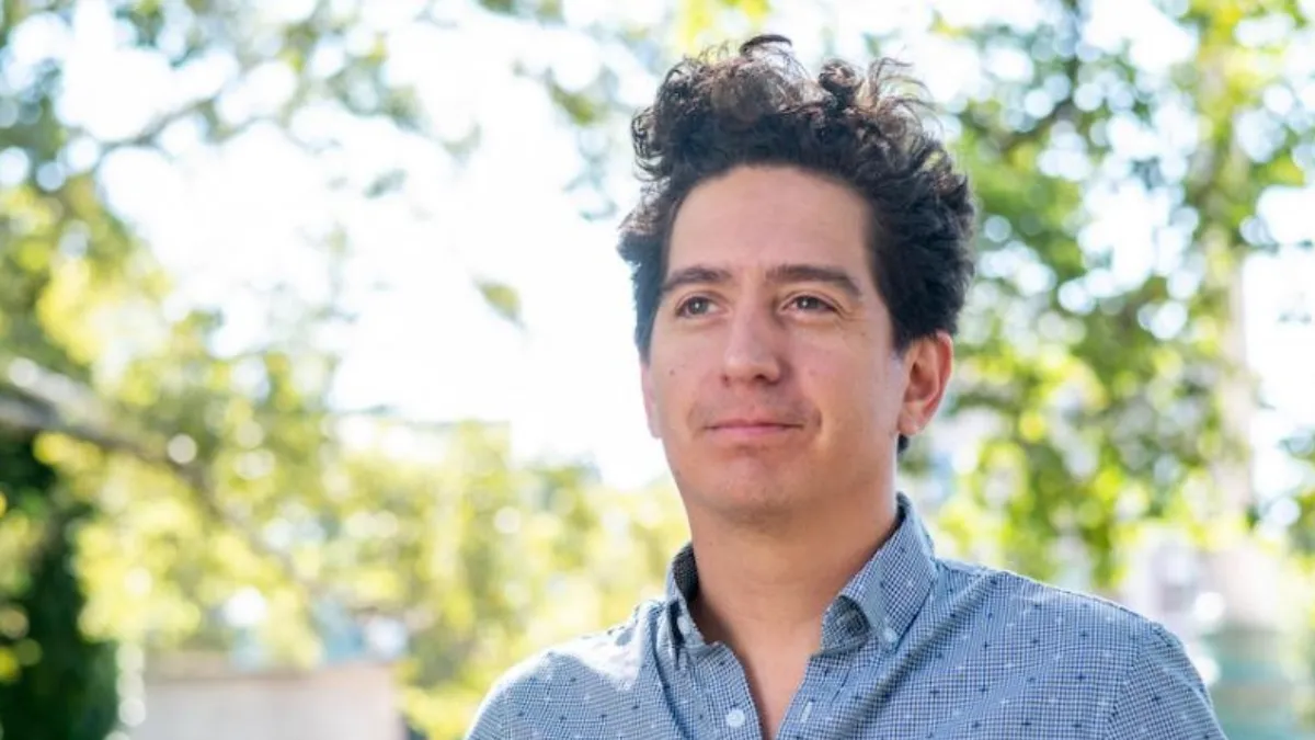 Photo of Daniel Alarcón with an outdoors backdrop. 