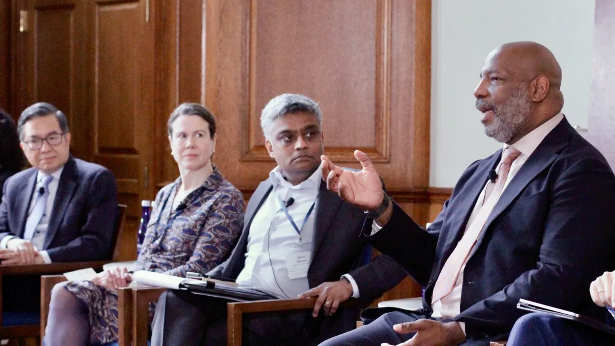 Panel discussion featuring individuals seated and engaged in conversation.
