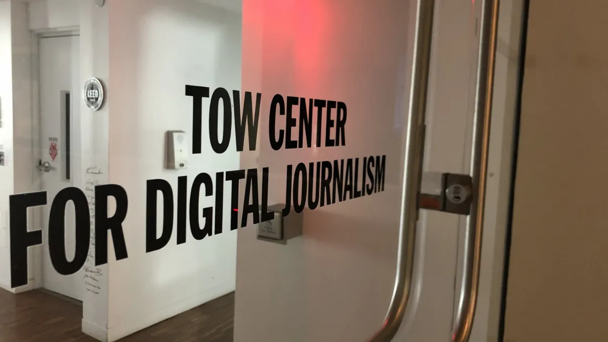 Glass door with "TOW CENTER FOR DIGITAL JOURNALISM" printed on it.