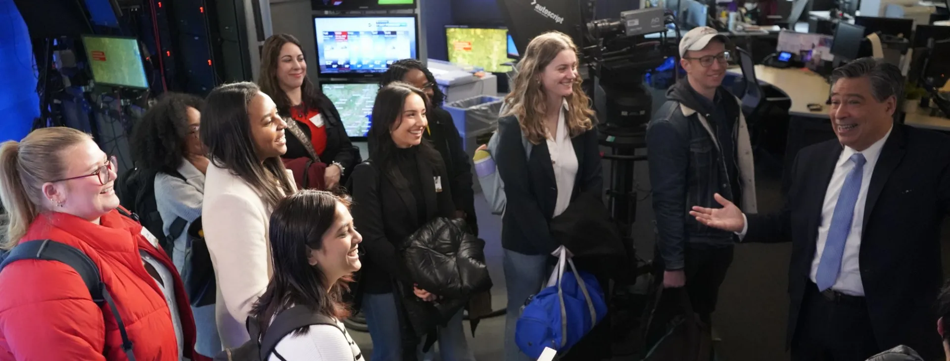 Students gather in a broadcast studio. 