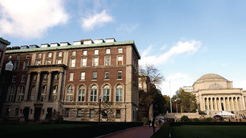 The outside entrance of Pulitzer Hall. The Low Memorial library is visible on the right